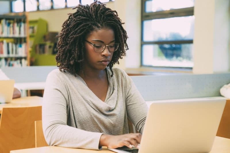 Woman taking proctored exam on computer